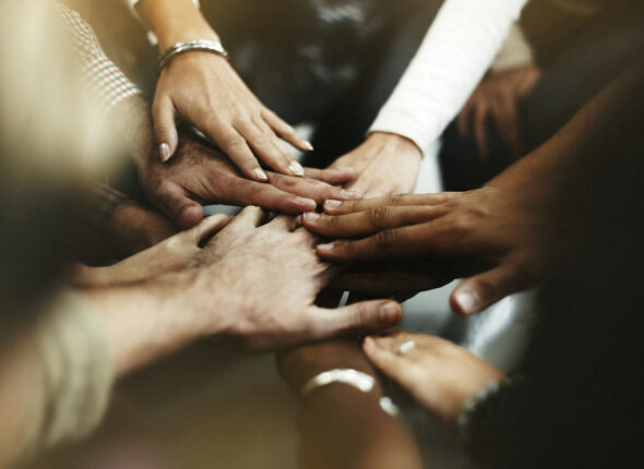 Closeup of diverse people joining their hands