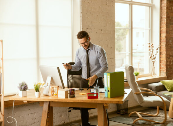 A young businessman moving in office, getting new work place