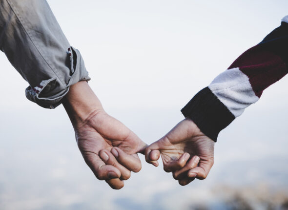 Valentine day background. Happy couple holding hands together as