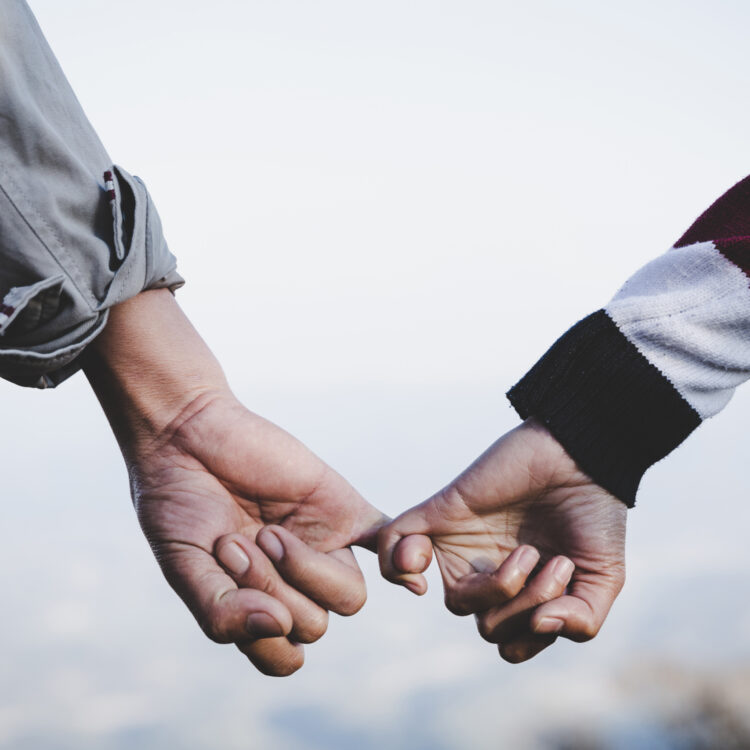 Valentine day background. Happy couple holding hands together as